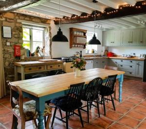 a kitchen with a large wooden table and chairs at Little Underhill in Oswestry