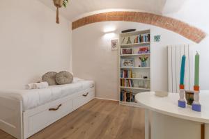a room with a bed and a book shelf at Affaccio sul Castellare in Siena