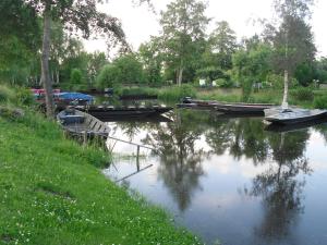 a group of boats are docked on a river at Ferienwohnung Spreewald pur in Stennewitz