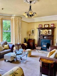 a living room with a couch and a table at Victorian Villa in New Ross
