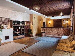 a large room with a lobby with a bar at RIAD MEDINA MUDEJAR BAÑOS ARABES in Toledo