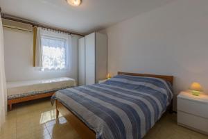 Postel nebo postele na pokoji v ubytování Apartments Crevatin