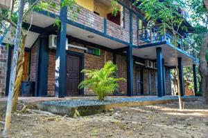 a brick building with a porch and a balcony at Vintara Eco Resort in Hambantota
