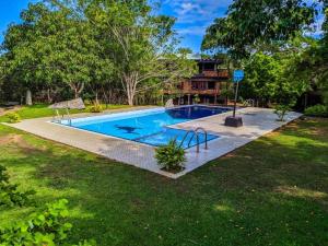 a swimming pool in the yard of a house at Vintara Eco Resort in Hambantota