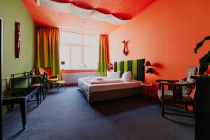 a hotel room with a bed and a window at LaLeLu Hostel Dresden in Dresden