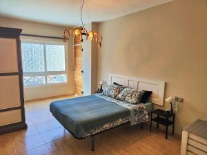 a bedroom with a bed and a large window at Casa Burbuja Azul in Gran Tarajal