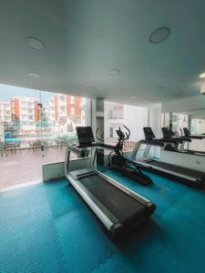 a gym with several treadmills and a laptop on a treadmill at Elegant Stay in Hurghada +7 photos