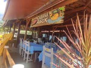 ヴィラ・ヴェーリャにあるCasa Vista do Mar, praia e piscinaの青いテーブルと白い椅子が備わるレストラン
