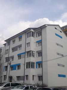 a white apartment building with blue accents at Bellacasa in Zalău