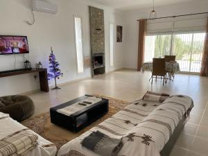 a living room with a couch and a christmas tree at Cheerful 2-bedroom Villa with pool 