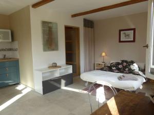 a bedroom with a bed and a table in it at Campagne de Saint Clair in Pertuis