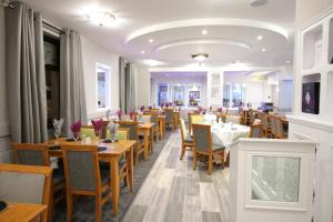a dining room with wooden tables and chairs at Stamps by Eight Continents The Royal Hotel, Cookstown in Cookstown