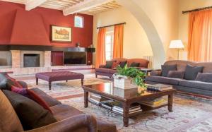 a living room with couches and a fireplace at Villa Pieve in Palaia