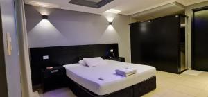 um quarto com uma grande cama branca num quarto em Gran Motel em Taguatinga