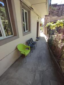 a group of chairs sitting next to a building at Wooden_Room_Hostel in Yerevan