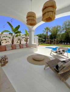 a patio with two chairs and two chandeliers at Celebrate Life's Precious Moments at Can Saca! in Sant Jordi