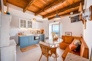 a kitchen with blue cabinets and a table in a room at Casa da Rocha - NEW in Câmara de Lobos