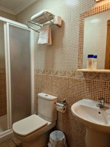 a bathroom with a toilet and a sink at Hostería VISTAPARK in El Astillero