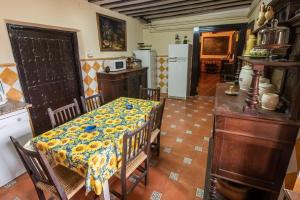 a kitchen with a table with a table cloth on it at Finca casa rural de la Mata in Toledo