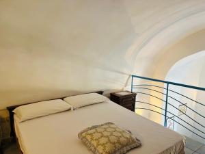 a bedroom with a bed with a pillow on it at Lunatica Immobilevante in Ponza