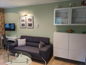 a living room with a couch and a table at Altenberger Stadtvilla in Dresden