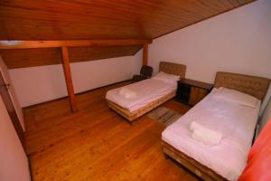 an attic room with two beds and a desk at Wooden_Room_Hostel in Yerevan