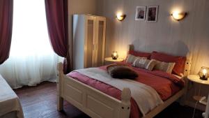 a cat sleeping on a bed in a bedroom at le 7 pompadour in Pompadour