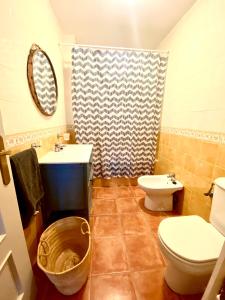 a bathroom with a toilet and a sink at Ático Islantilla Golf in Islantilla +18 photos