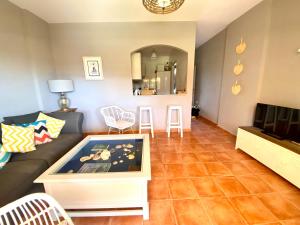 a living room with a couch and a table at Ático Islantilla Golf in Islantilla