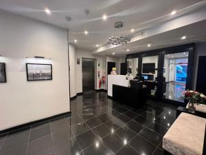 a large room with a lobby with a reception desk at Great St Helen Hotel in London