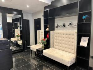 a dressing room with two chairs and mirrors at Great St Helen Hotel in London