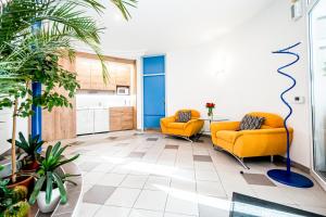 an office with two orange chairs and a table at Hotel Squash Dependance in Prievidza