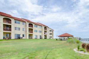a large apartment building with a large yard at Sunset Harbor Palms 2 102 Luzviminda Cove in Navarre