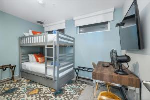 a bedroom with a bunk bed and a desk at Oceanview Paradise In The One Happy Island in Oranjestad
