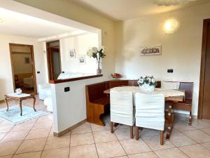 a kitchen and dining room with a table and chairs at Casa Fantasia in Tremezzo