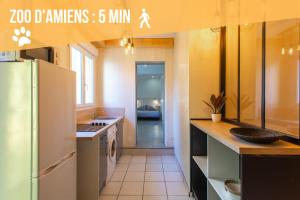 a kitchen with a white refrigerator and a sink at Chill & Sun - Terrasse extérieure - Parking - Wifi - 4p in Amiens