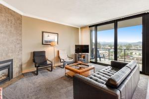 a living room with a couch and a fireplace at Sand & Sea: Neawanna Creek (414) in Seaside