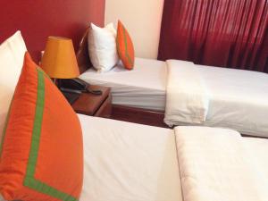 Postel nebo postele na pokoji v ubytování Mekong Angkor Palace Inn
