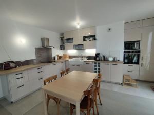 eine Küche mit einem Holztisch und Stühlen in der Unterkunft Rueil-Malmaison appartement spacieux et calme in Rueil-Malmaison