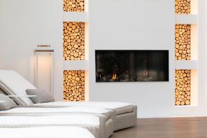 a living room with a fireplace and a white couch at Grand Hotel Fasano & Villa Principe in Gardone Riviera