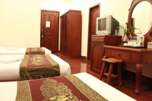 Postel nebo postele na pokoji v ubytování Mekong Angkor Palace Inn