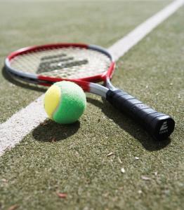 a tennis racket on a tennis court at Quality Resort Siesta in Albury