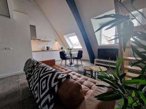 a living room with a couch and a table at Woonhotel Petruskerk in Vlissingen