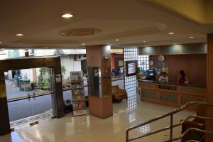 a lobby of a building with a counter in it at Federal Hotel Kangar Perlis in Kangar