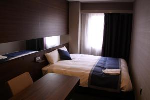 Postel nebo postele na pokoji v ubytování Hotel Il Credo Gifu