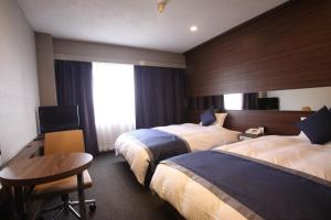 Postel nebo postele na pokoji v ubytování Hotel Il Credo Gifu