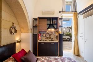 a kitchen with a sink and a stove in a room at Monolocale Delux Alithia in Muro Leccese +12 photos