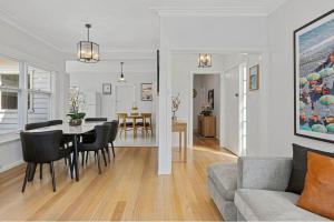 a living room and dining room with a table and chairs at Soak up Sorrento The Perfect Coastal Getaway in Sorrento