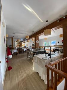 a restaurant with tables and chairs with a santa hat at Hotel Tirol in Formigal