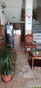 a waiting room with a chair and a table and stairs at Alojamento Dona Inês de Castro in Atouguia da Baleia